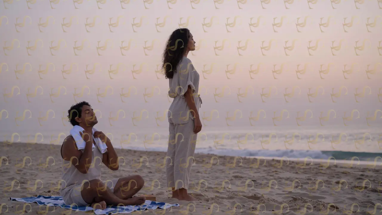 A serene Brazilian woman standing barefoot on a Dubai beach at dawn, offering quiet comfort to a client nearby.